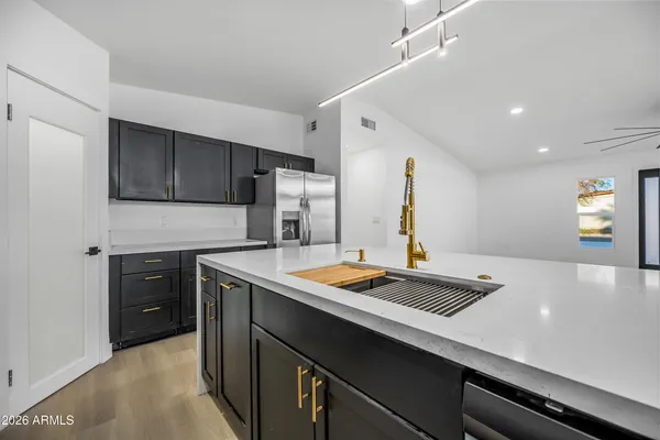 a kitchen with a refrigerator and cabinets