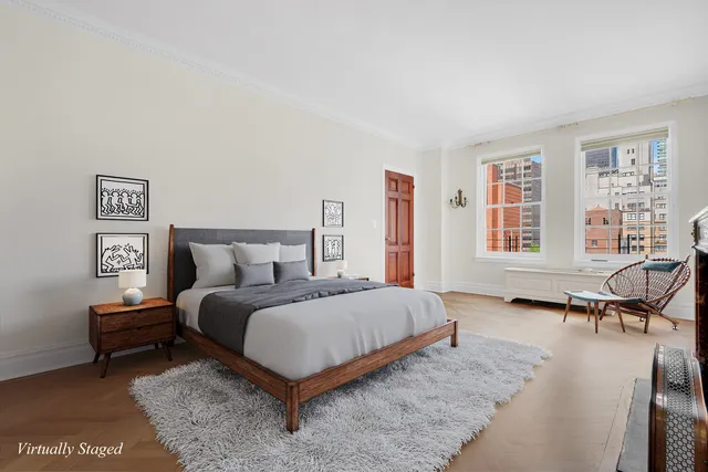 a bedroom with a bed a table and chair