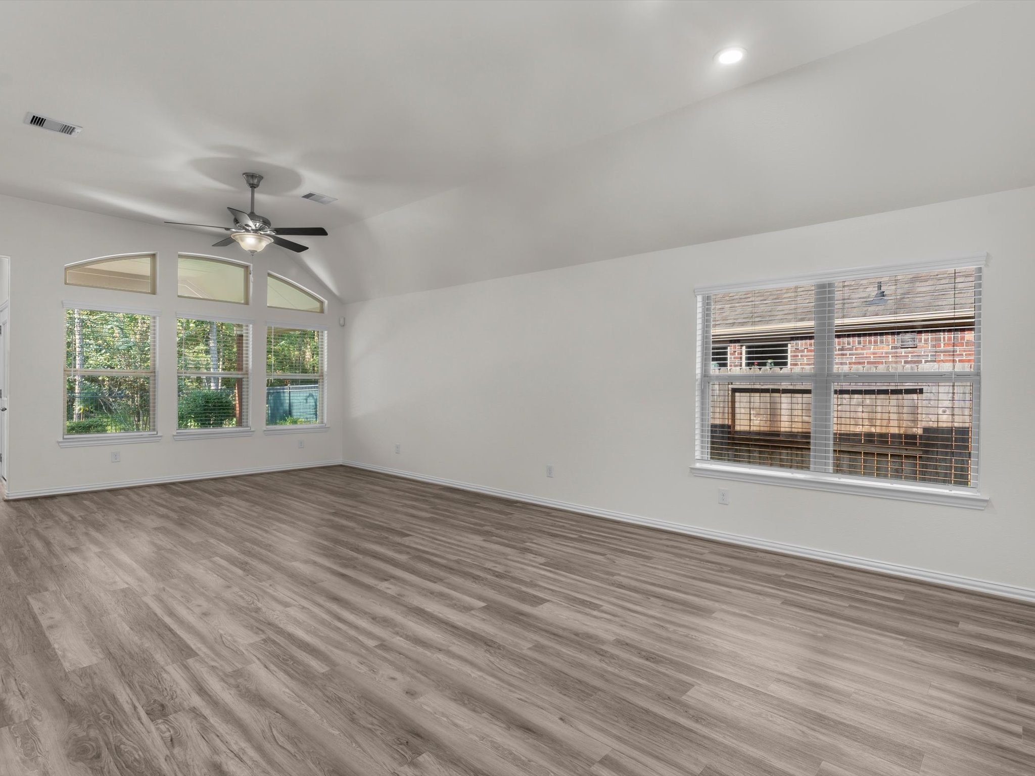 4746 Misty Ranch Drive Spring, TX 77386 - Photo 8 of 49 Spacious living room with fresh paint, new blinds, and an open view of the kitchen and dining area.