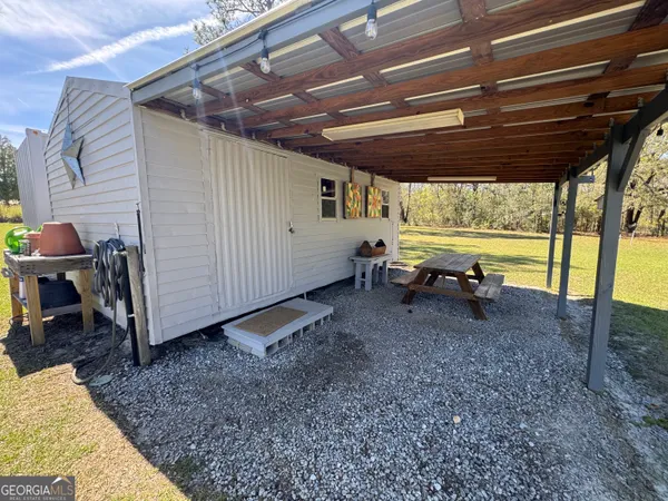 a view of a porch with furniture and a yard