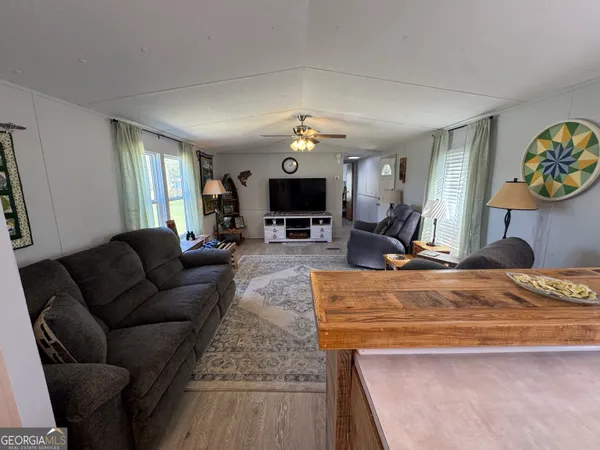 a living room with fireplace furniture and a chandelier