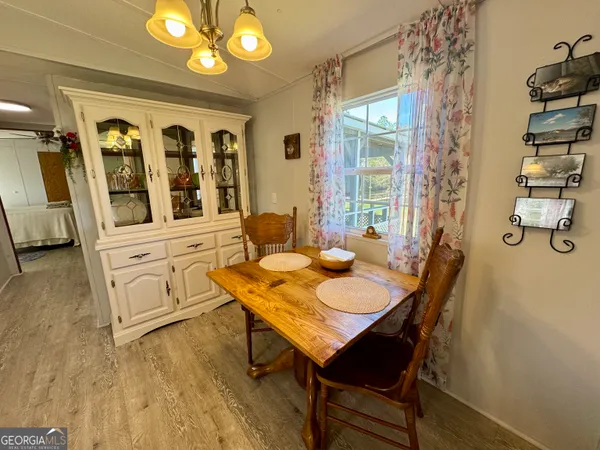 a view of a dining room with furniture and chandelier