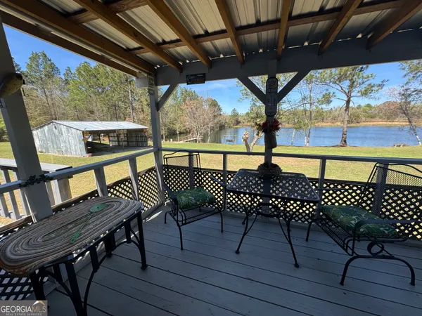 a view of a chairs and table on the deck
