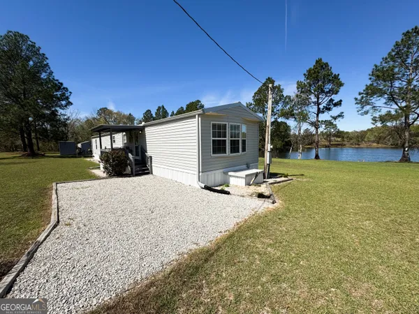 a view of a house with backyard porch and sitting area