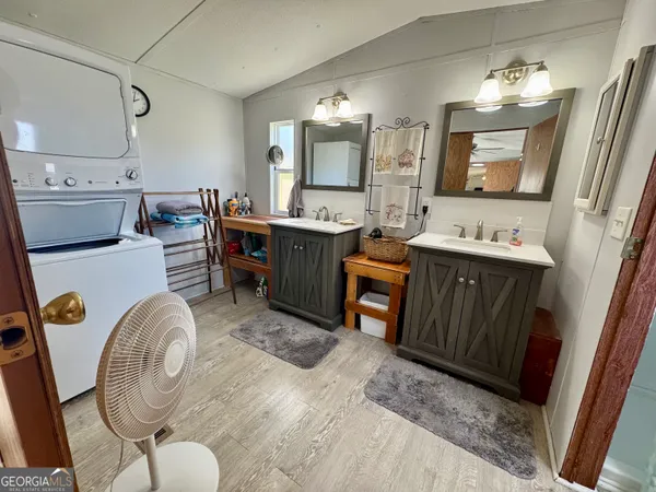 a room with furniture a mirror a sink and a window