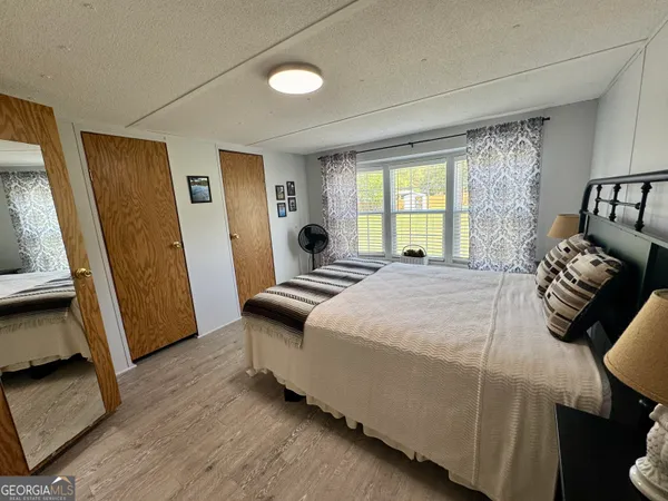 a bedroom with a bed and a mirror
