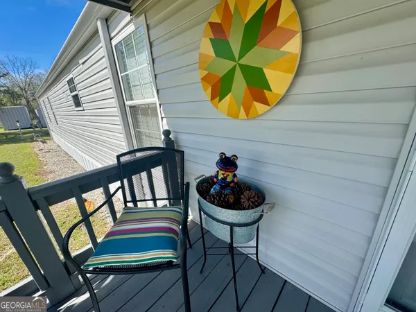 a view of a chairs and table in the balcony