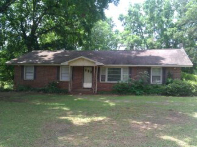 169 Ethridge Road Haddock, GA 31033 - Photo 1 of 1 a front view of a house with a garden