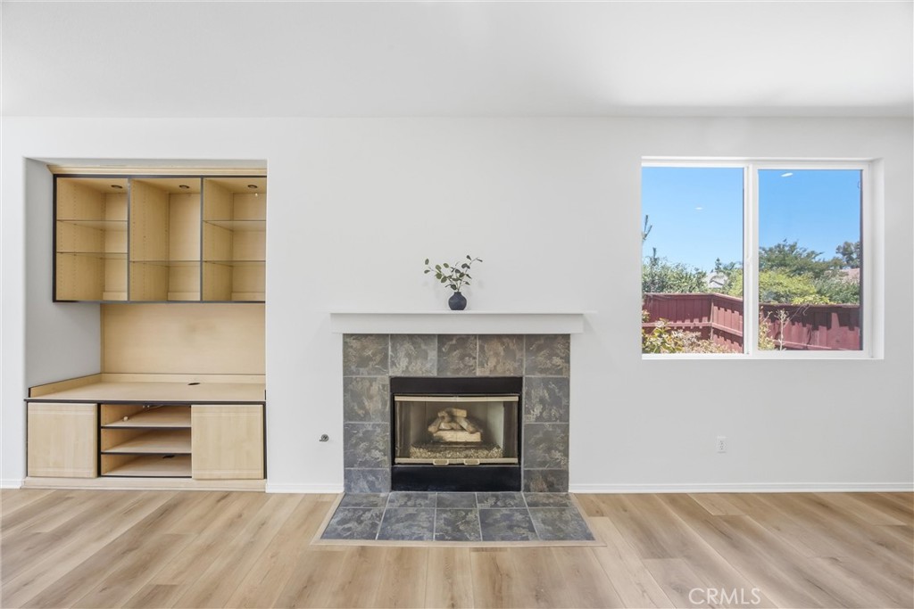 8710 Windmill Place Riverside, CA 92508 - Photo 21 of 66 a view of an empty room with a fireplace and a window