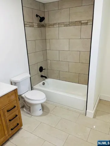 a bathroom with a toilet and a bathtub