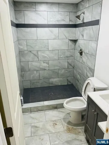 a bathroom with a toilet and a shower
