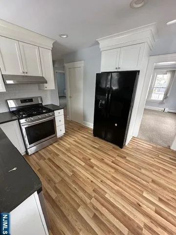 a kitchen with a stove and a refrigerator