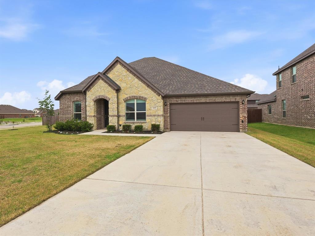 a front view of a house with a yard and garage