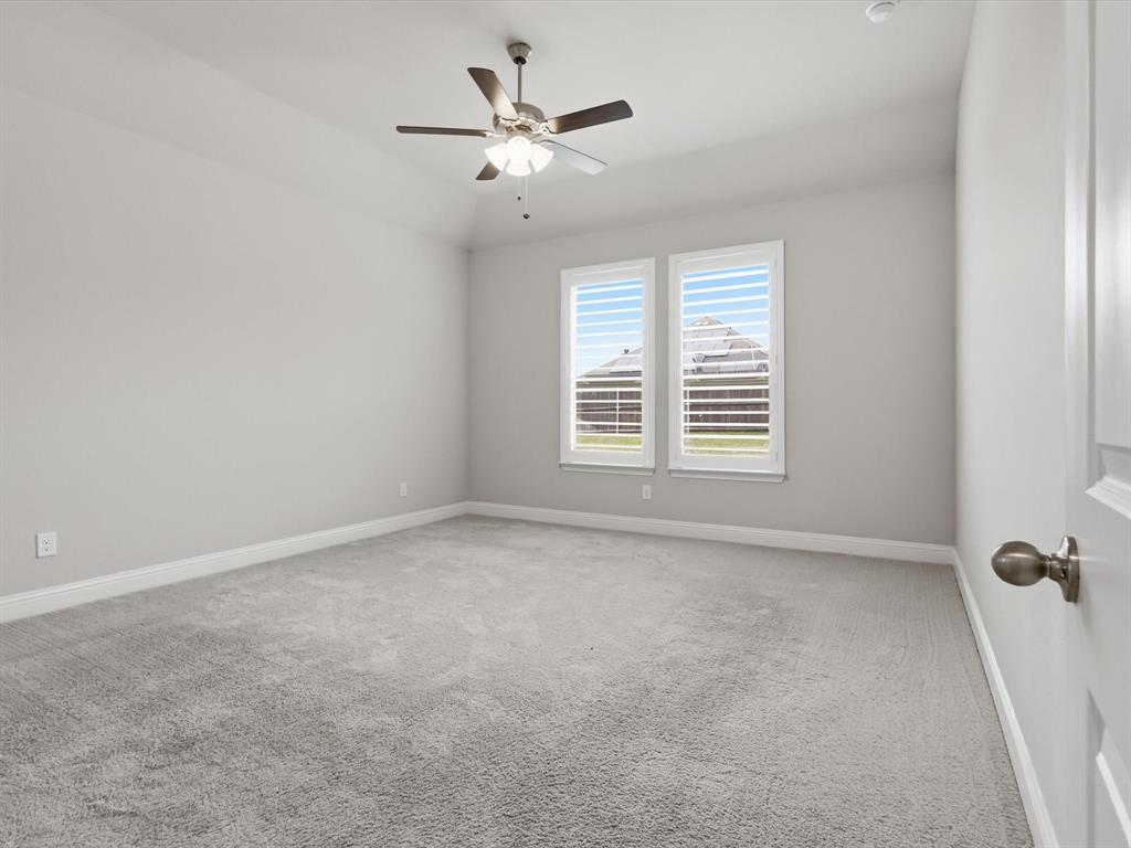1601 Radecke Road Krum, TX 76249 - Photo 11 of 32 an empty room with windows and fan