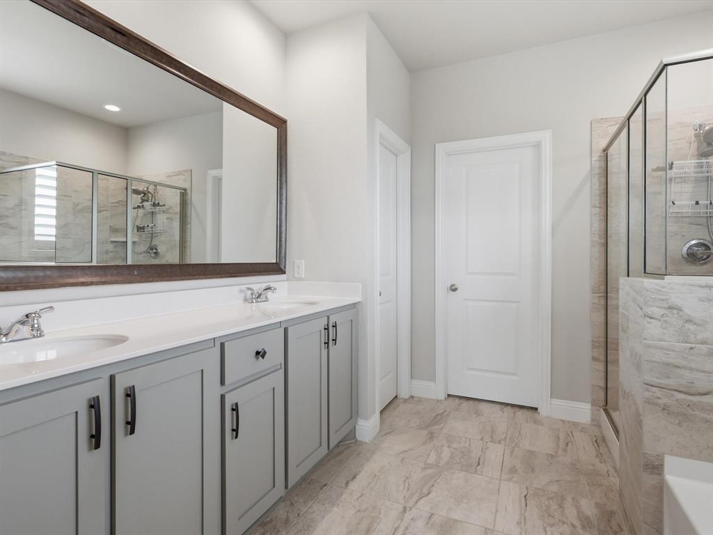 1601 Radecke Road Krum, TX 76249 - Photo 14 of 32 a bathroom with a double vanity sink and mirror