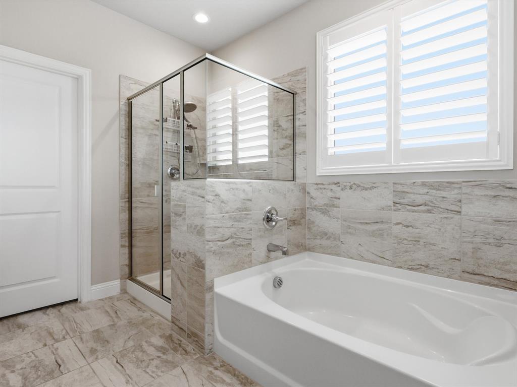 1601 Radecke Road Krum, TX 76249 - Photo 15 of 32 a bathroom with a bathtub and a shower