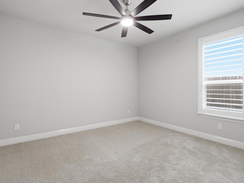 1601 Radecke Road Krum, TX 76249 - Photo 22 of 32 an empty room with a window and a fan