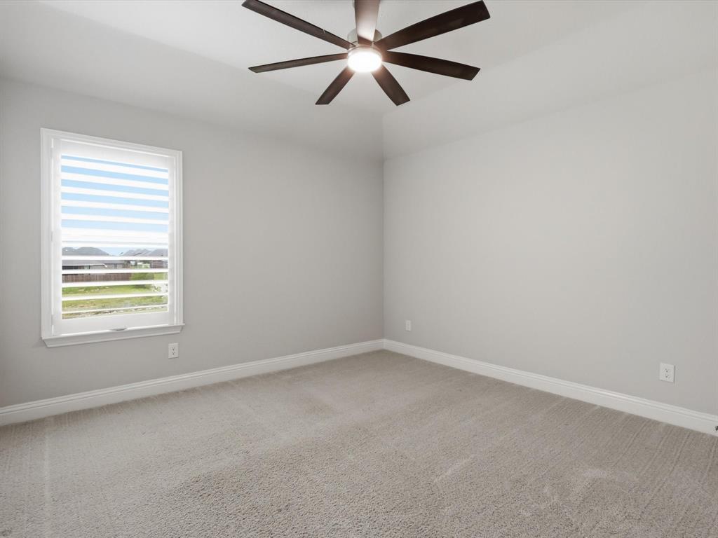 1601 Radecke Road Krum, TX 76249 - Photo 23 of 32 an empty room with a window and a fan