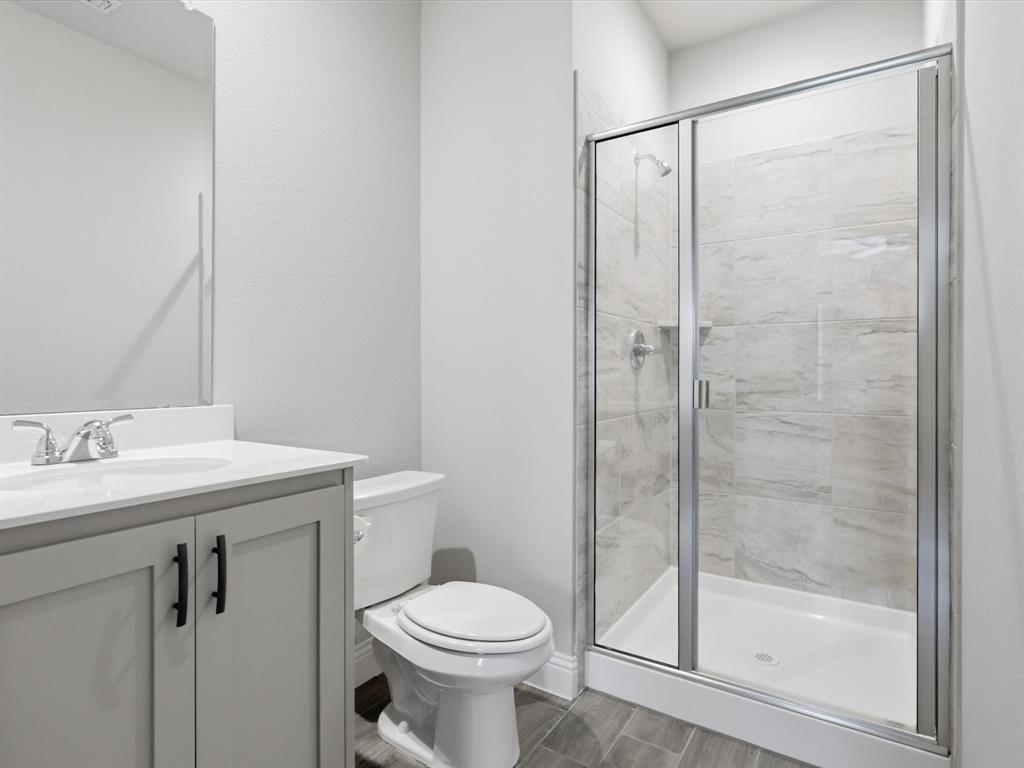 1601 Radecke Road Krum, TX 76249 - Photo 25 of 32 a bathroom with a shower a toilet and a sink
