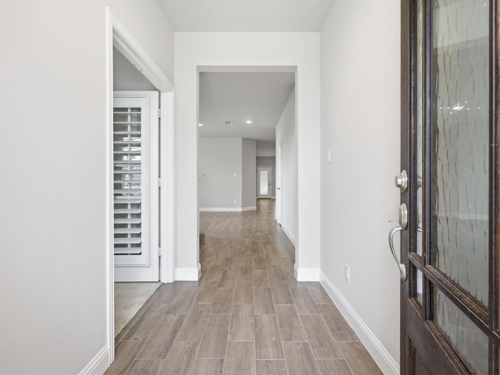 1601 Radecke Road Krum, TX 76249 - Photo 3 of 32 a view of a hallway with wooden floor and staircase