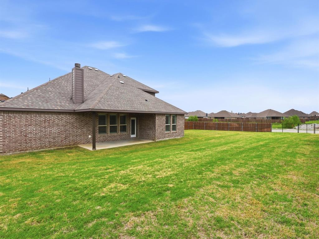 1601 Radecke Road Krum, TX 76249 - Photo 30 of 32 a front view of a house with a garden
