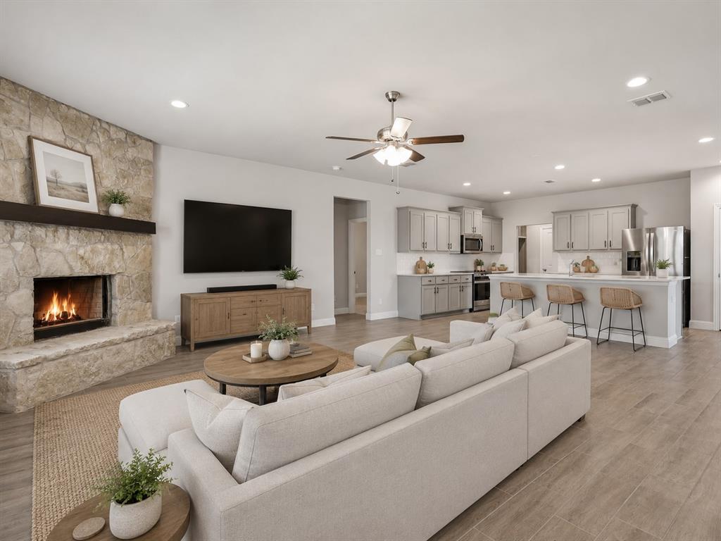 1601 Radecke Road Krum, TX 76249 - Photo 4 of 32 a living room with furniture flat screen tv and a fireplace