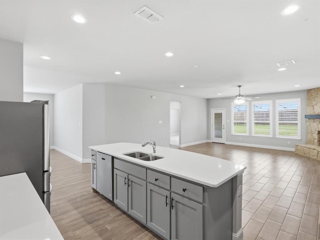 1601 Radecke Road Krum, TX 76249 - Photo 7 of 32 a kitchen with sink and refrigerator