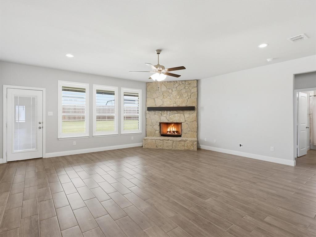 1601 Radecke Road Krum, TX 76249 - Photo 9 of 32 an empty room with windows and fireplace