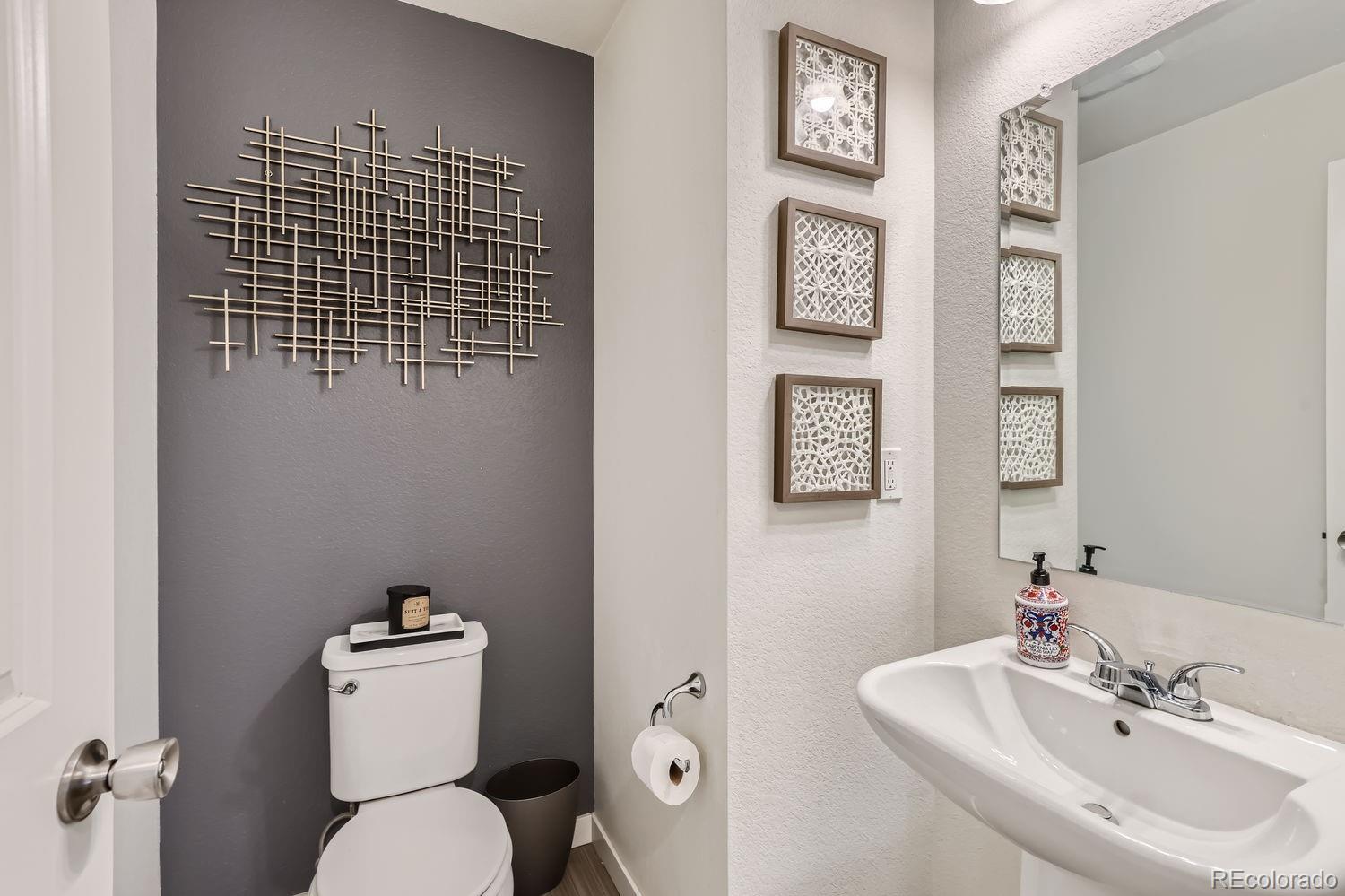 5266 Central Park Boulevard Denver, CO 80238 - Photo 12 of 23 a bathroom with a toilet sink and mirror