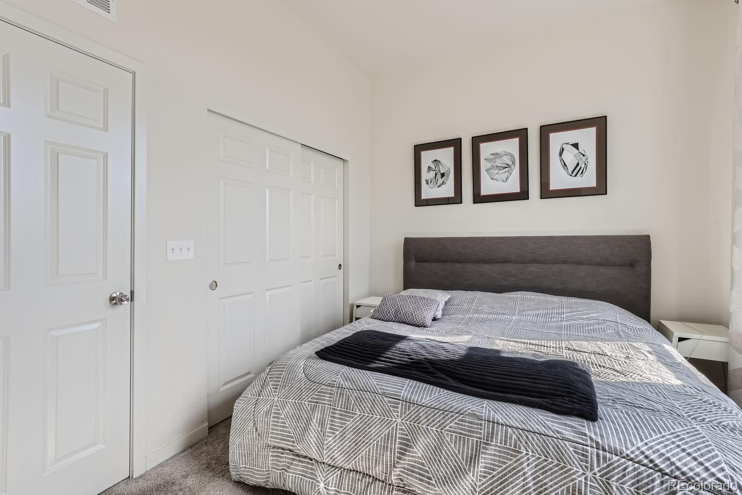 5266 Central Park Boulevard Denver, CO 80238 - Photo 13 of 23 a bedroom with a bed and a painting on the wall