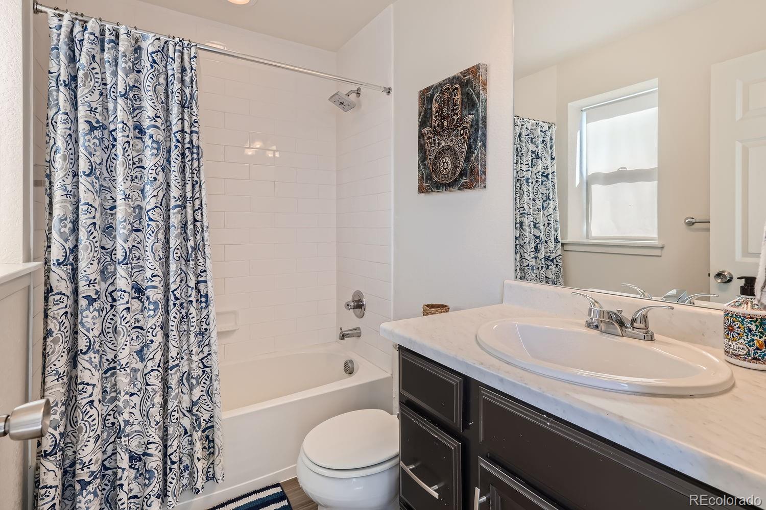5266 Central Park Boulevard Denver, CO 80238 - Photo 14 of 23 a bathroom with a sink toilet and shower