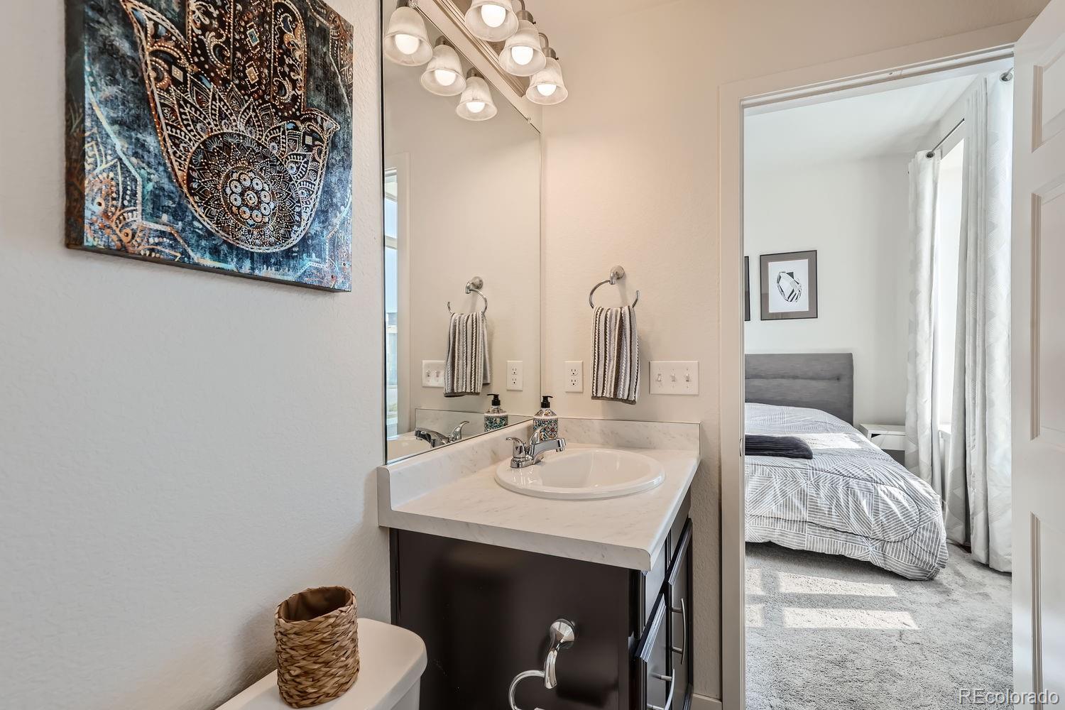 5266 Central Park Boulevard Denver, CO 80238 - Photo 15 of 23 a en suite bathroom with a sink and a mirror