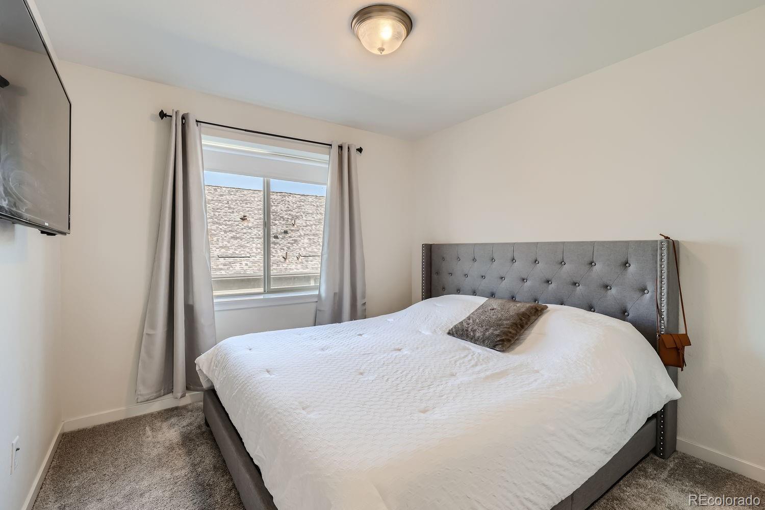 5266 Central Park Boulevard Denver, CO 80238 - Photo 18 of 23 a bedroom with a bed and a window