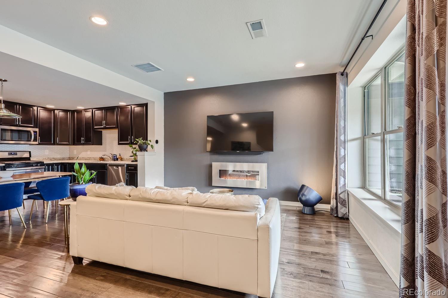 5266 Central Park Boulevard Denver, CO 80238 - Photo 6 of 23 a living room with furniture and a flat screen tv