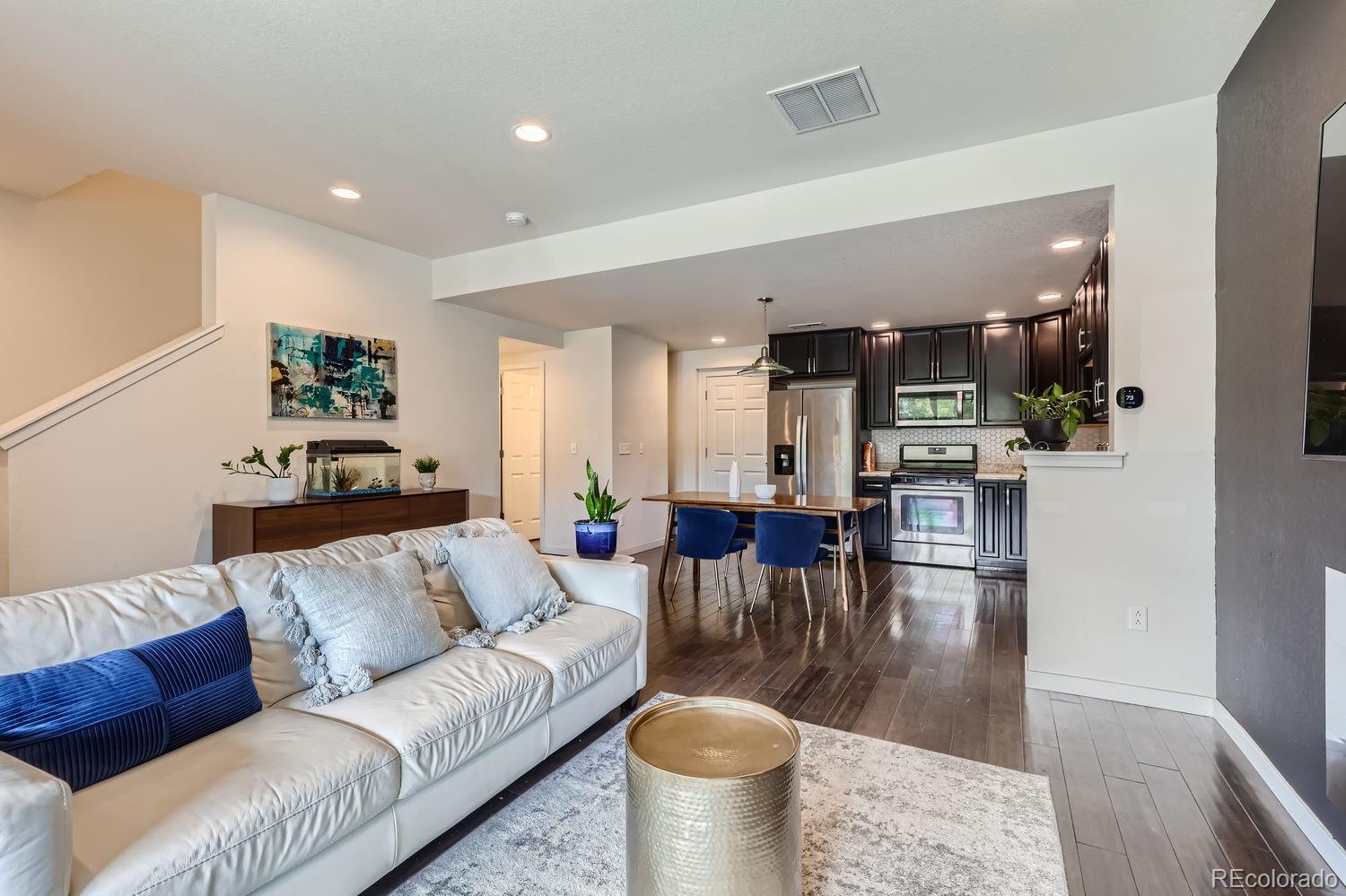 5266 Central Park Boulevard Denver, CO 80238 - Photo 8 of 23 a living room with furniture and kitchen view