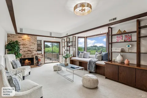 a living room with furniture fireplace and a large window