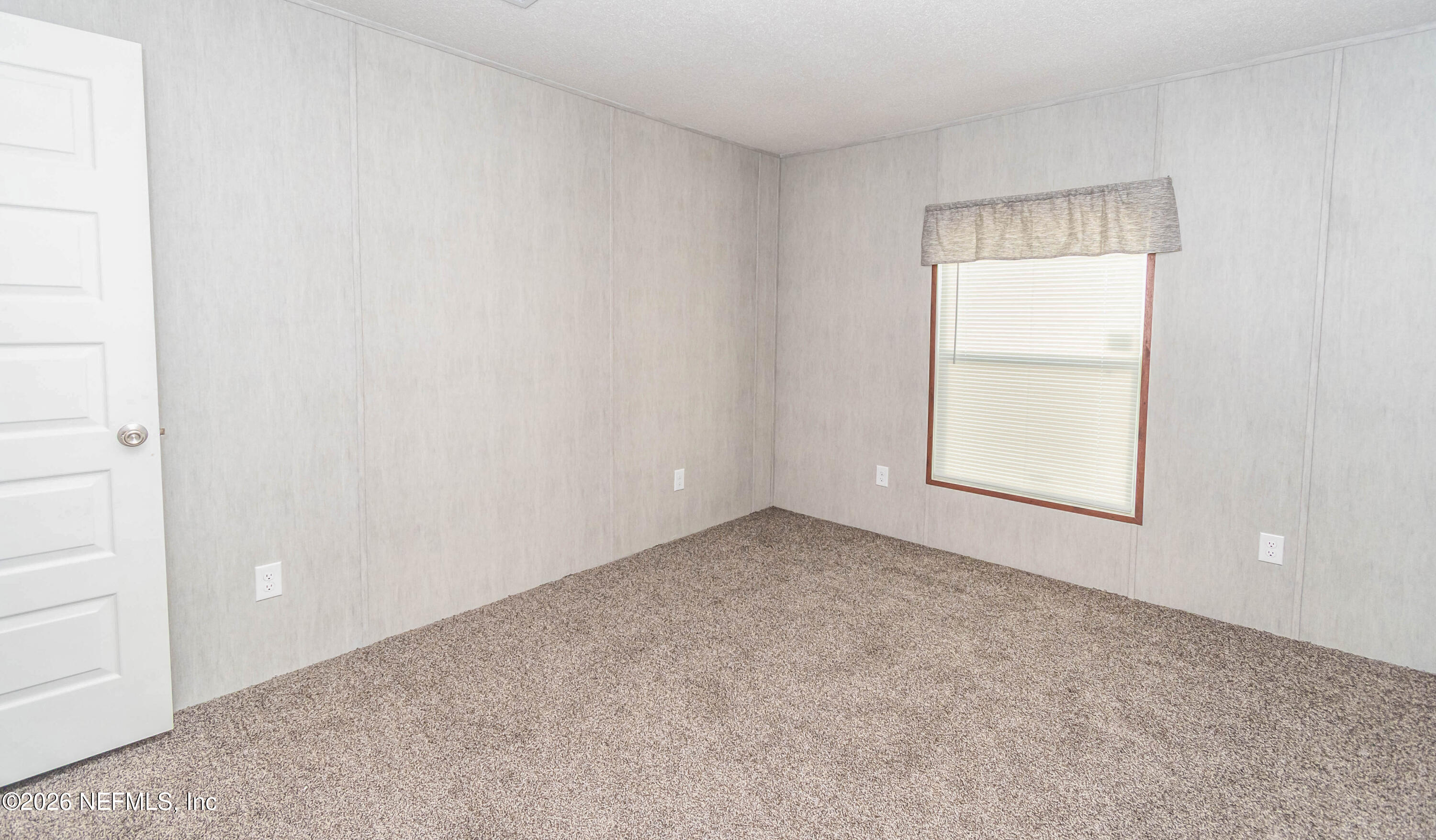 6171 Bill Davis Road Glen St. Mary, FL 32040 - Photo 19 of 28 an empty room with windows and closet