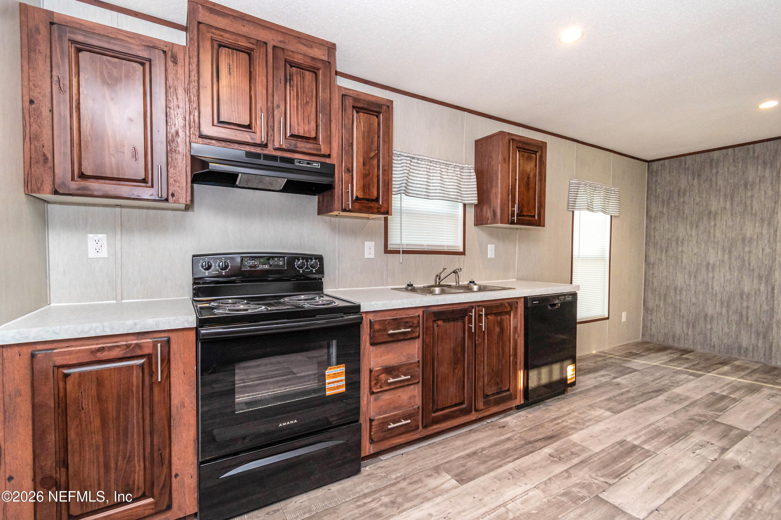 6171 Bill Davis Road Glen St. Mary, FL 32040 - Photo 4 of 28 a kitchen with stainless steel appliances granite countertop a stove and a sink