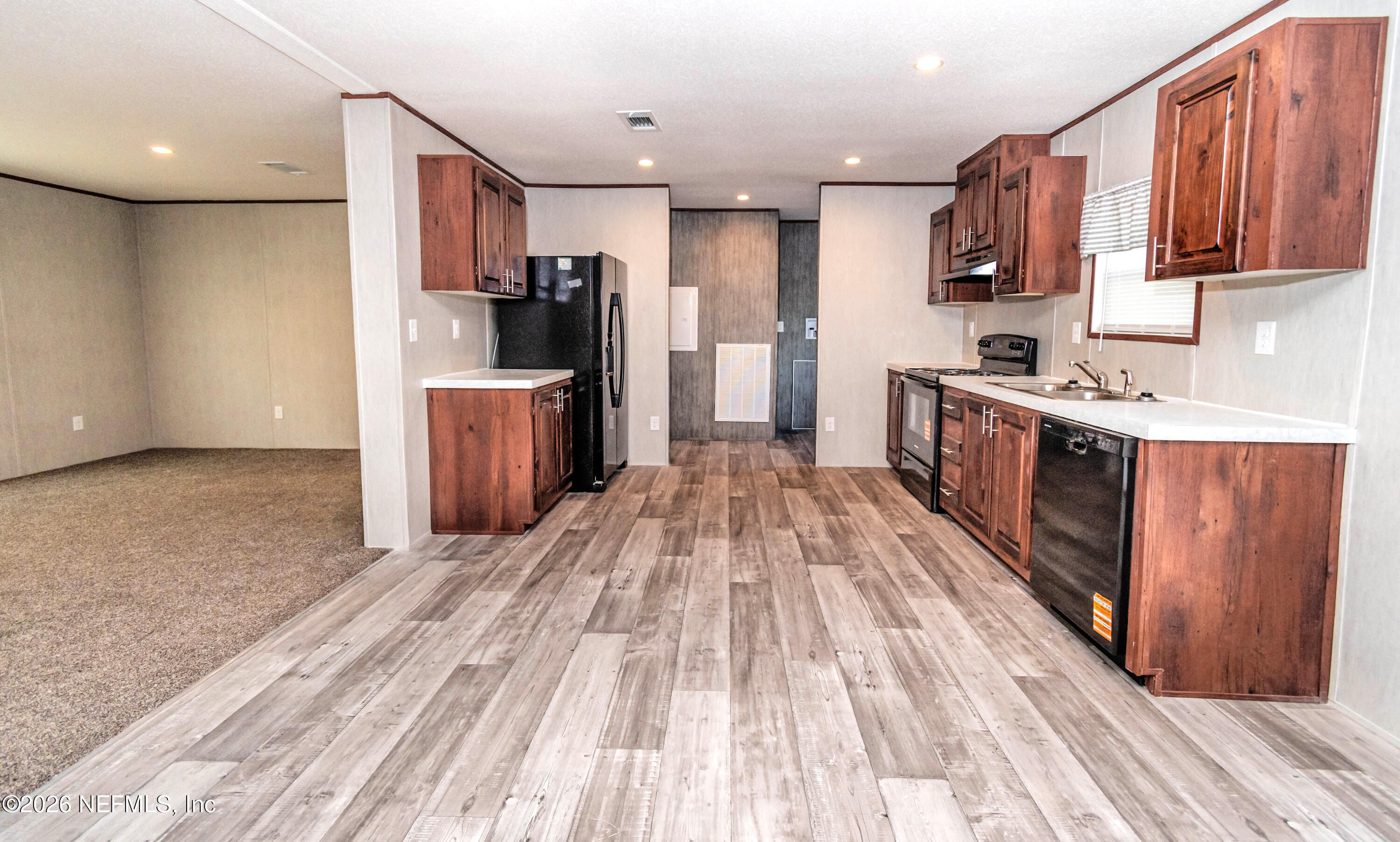 6171 Bill Davis Road Glen St. Mary, FL 32040 - Photo 5 of 28 a kitchen with a sink and wooden cabinets
