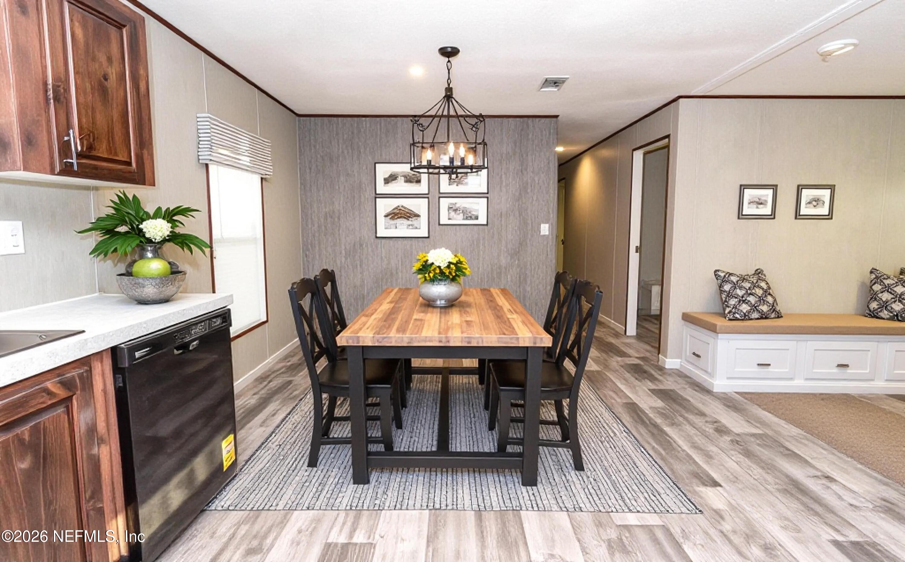 6171 Bill Davis Road Glen St. Mary, FL 32040 - Photo 6 of 28 a view of a dining room with furniture window and wooden floor