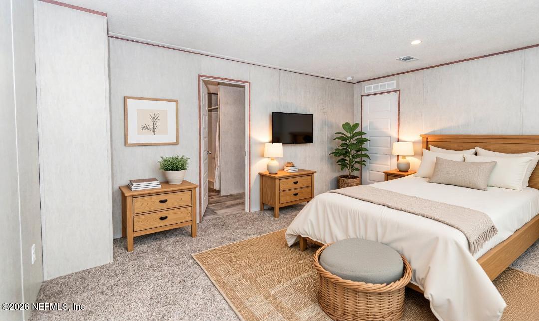 6171 Bill Davis Road Glen St. Mary, FL 32040 - Photo 7 of 28 a bedroom with a bed and furniture