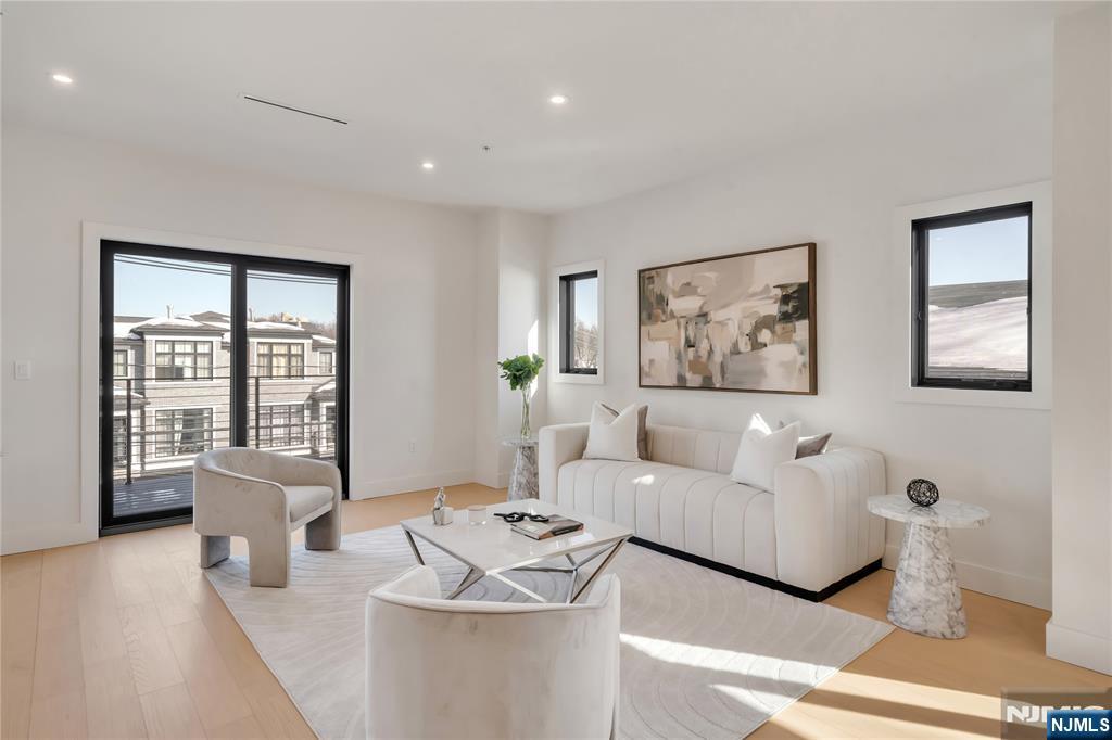 2220 MacKay Avenue, Unit A Fort Lee, NJ 07024 - Photo 13 of 45 a living room with furniture and large windows