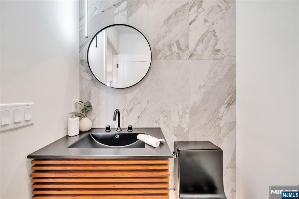 2220 MacKay Avenue, Unit A Fort Lee, NJ 07024 - Photo 17 of 45 a bathroom with a sink and a mirror