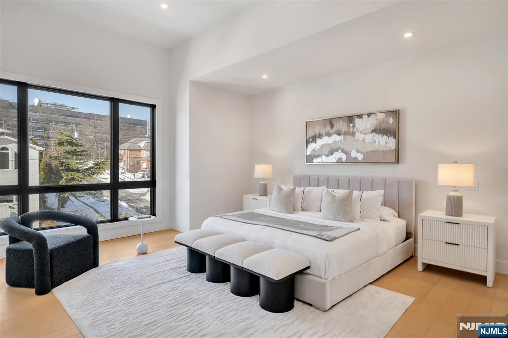 2220 MacKay Avenue, Unit A Fort Lee, NJ 07024 - Photo 19 of 45 a bedroom with a large bed and a large window