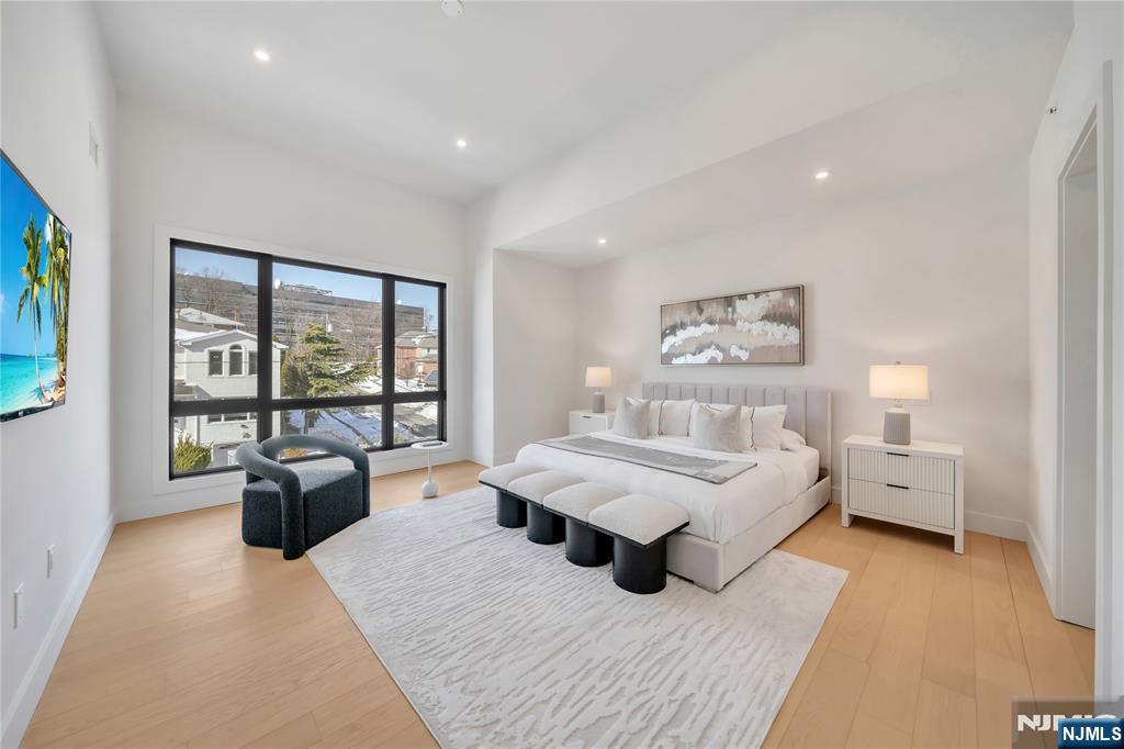 2220 MacKay Avenue, Unit A Fort Lee, NJ 07024 - Photo 21 of 45 a living room with furniture and large windows with wooden floor