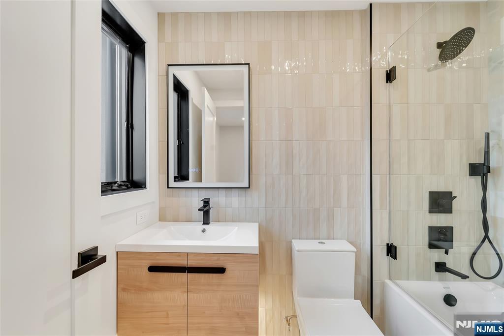 2220 MacKay Avenue, Unit A Fort Lee, NJ 07024 - Photo 25 of 45 a bathroom with a sink a toilet and shower