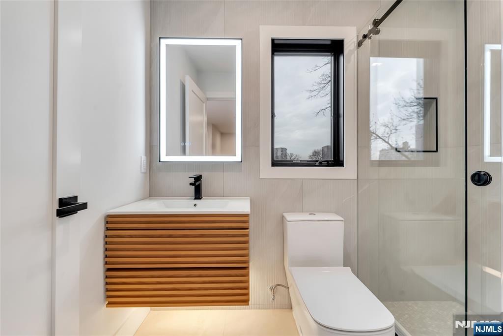 2220 MacKay Avenue, Unit A Fort Lee, NJ 07024 - Photo 34 of 45 a bathroom with a sink a toilet and shower