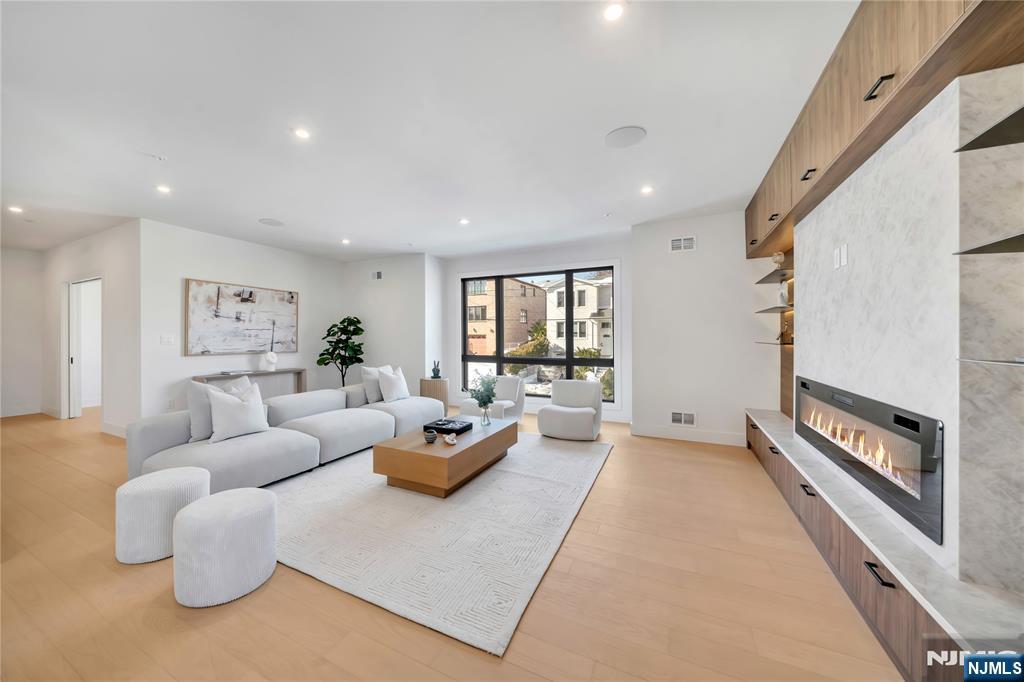 2220 MacKay Avenue, Unit A Fort Lee, NJ 07024 - Photo 6 of 45 a living room with furniture and a fireplace