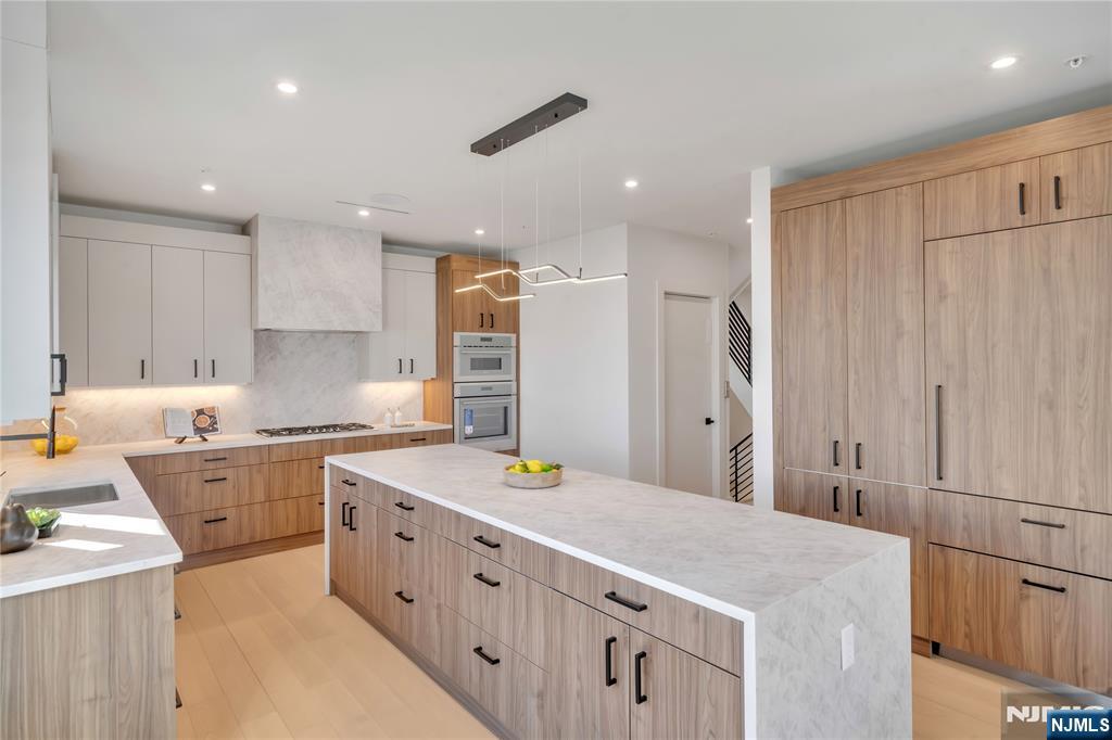 2220 MacKay Avenue, Unit A Fort Lee, NJ 07024 - Photo 9 of 45 a kitchen that has a lot of cabinets in it wooden floor and wooden floors