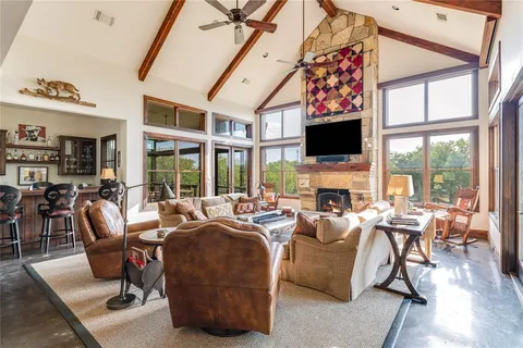 a living room with fireplace furniture and a flat screen tv